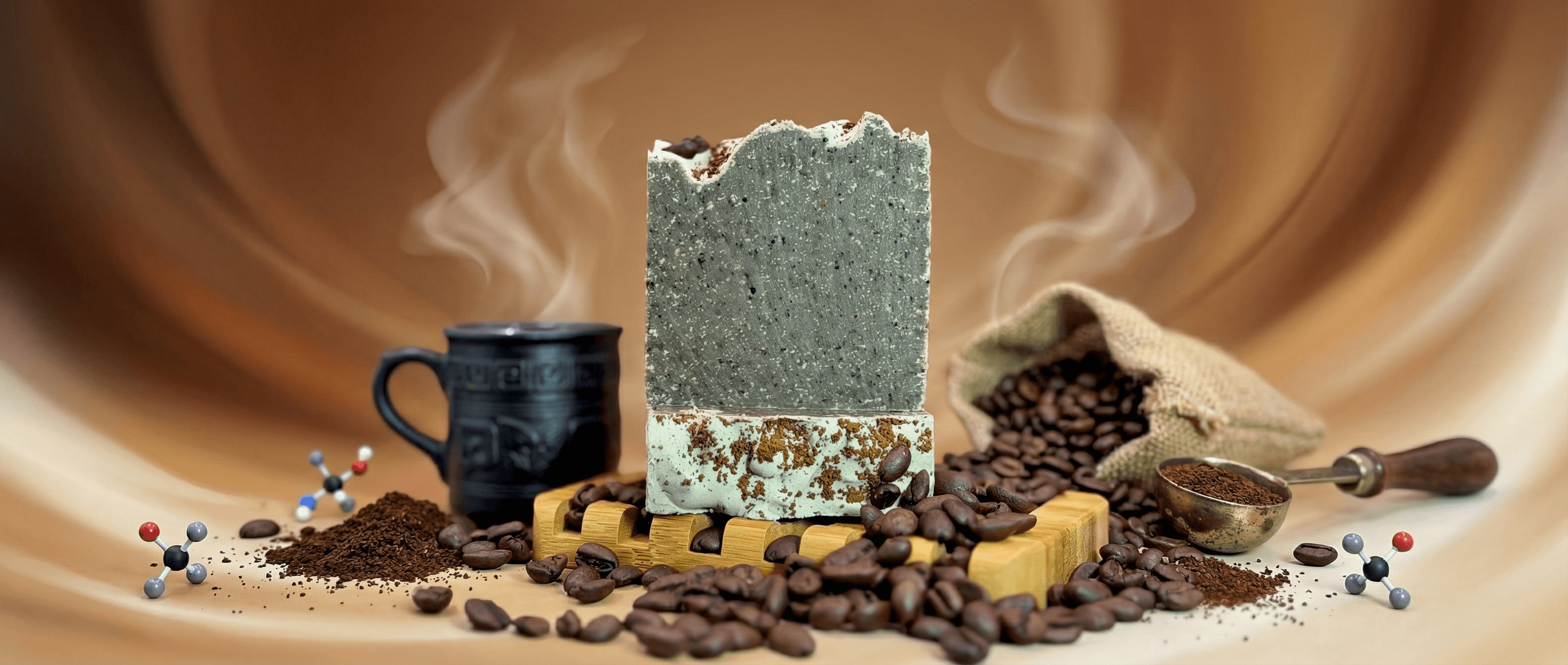 Two stacked handmade soap bars on wooden soap dish, gray-green top bar with speckled texture, cream bottom bar with coffee grounds, surrounded by scattered coffee beans and ground coffee.